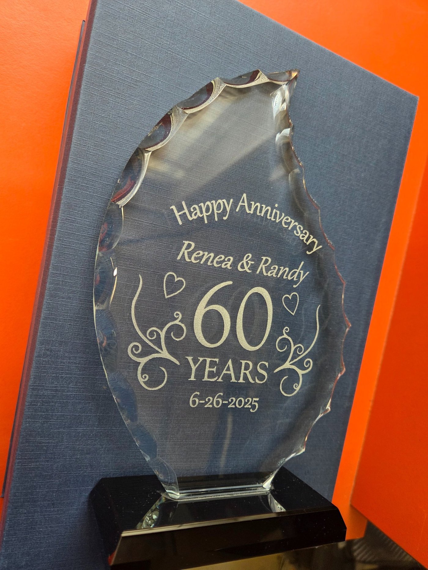 A cut-glass award engraved Happy Anniversary, Renea and Randy, 60 Years, 6-26-2025.