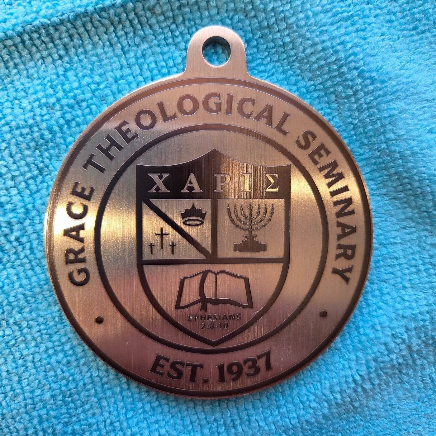 A bronze-toned medallion fiber-engraved with the Grace Theological Seminary crest and Est. 1937.