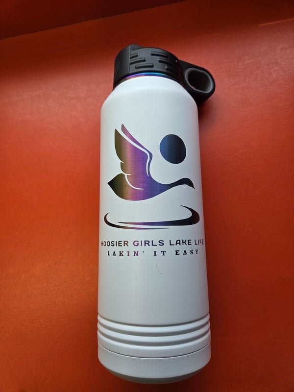A white insulated bottle engraved with a colour-shifted bird logo reading Hoosier Girls Lake Life, Lakin' It Easy.