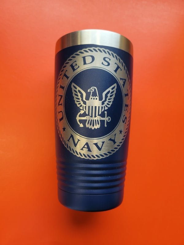 A navy blue tumbler engraved with the United States Navy eagle and anchor crest.