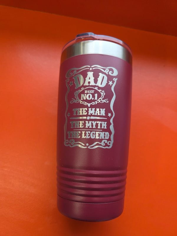 A maroon tumbler engraved Dad, Best No. 1, The Man, The Myth, The Legend.