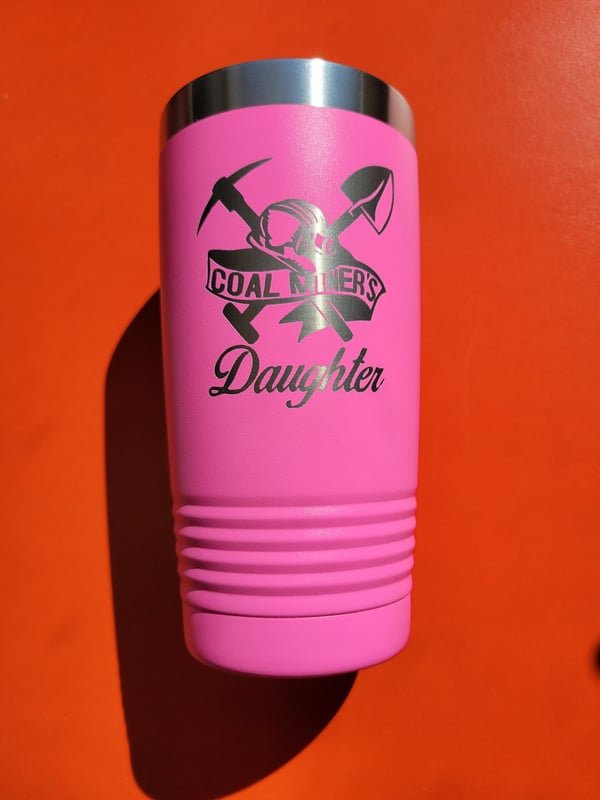 A pink tumbler engraved with crossed mining tools and the words Coal Miners Daughter.