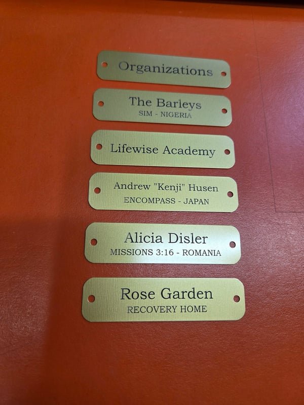 Five brass name plates engraved for organisations including Lifewise Academy, Rose Garden Recovery Home and Missions 3:16 Romania.