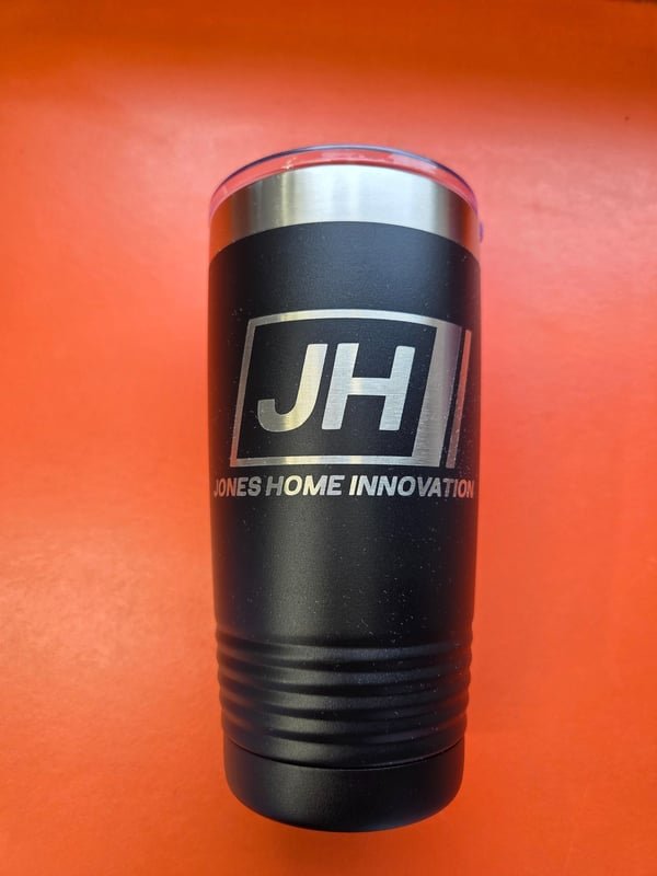 A black tumbler engraved with the JH Jones Home Innovation logo.