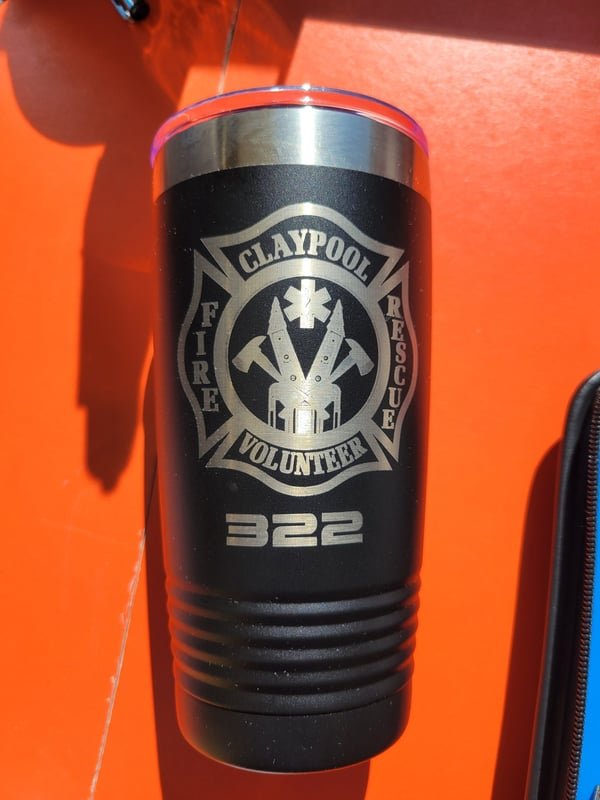 A black tumbler engraved with the Claypool Fire Rescue Volunteer crest and the number 322.