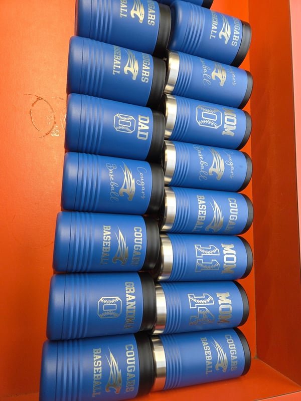 Rows of blue shotgun shells, each fiber-engraved with a name or number.