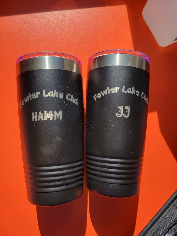 Two black tumblers engraved Fowler Lake Club with the names Hamm and JJ.