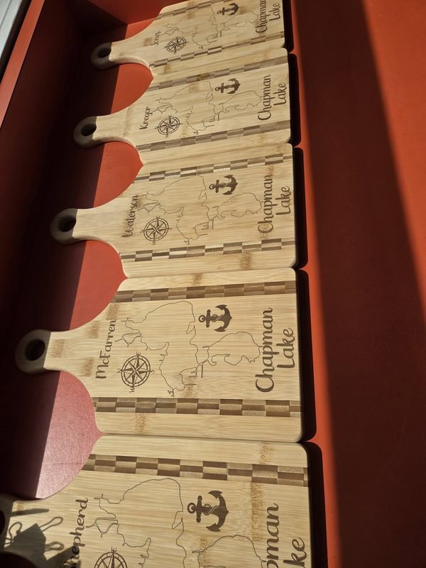 Engraved Chapman Lake paddle boards stacked in a shipping box ready to go out.