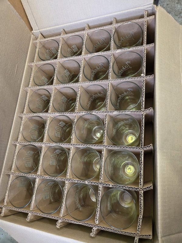 Etched pint glasses packed in a divided carton, ready to ship.
