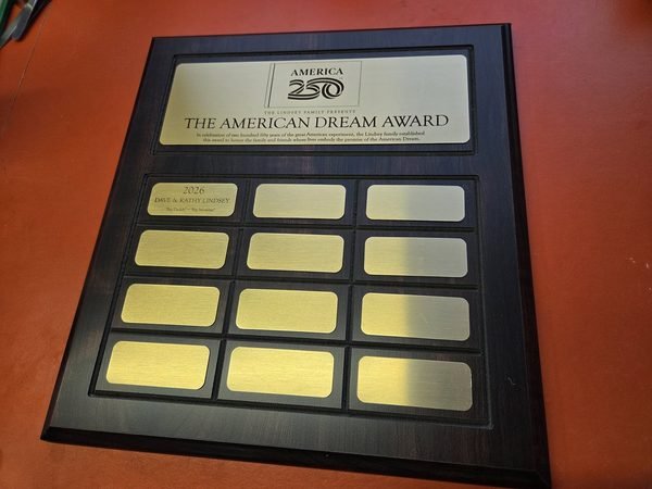 A perpetual recognition plaque for the America 250 American Dream Award, fitted with twelve engraved gold name plates.