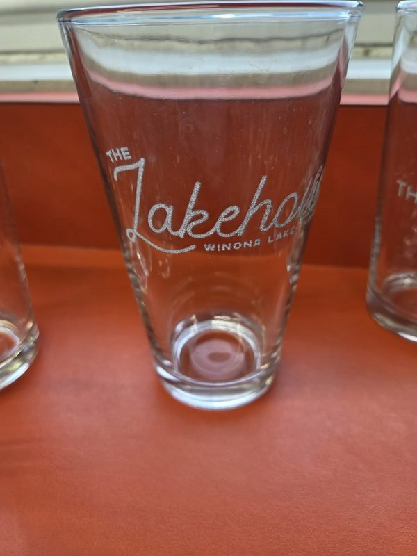 A tall pint glass etched with The Lakehouse, Winona Lake script logo.