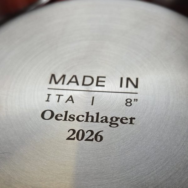 A close-up of a stainless pan base fiber-engraved Made in ITA, 8 inch, Oelschlager 2026.