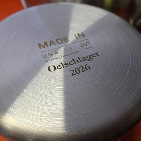 A stainless pan base fiber-engraved Made in USA, 2QT, with the family name and year.