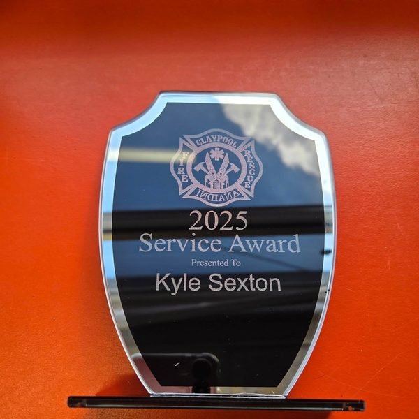 A mirrored acrylic shield award engraved with the Claypool Fire Rescue crest above 2025 Service Award, Kyle Sexton.