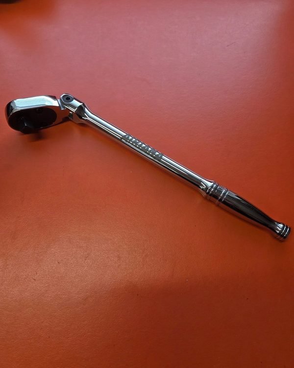 A chrome socket ratchet fiber-engraved along the handle with its owner's name.