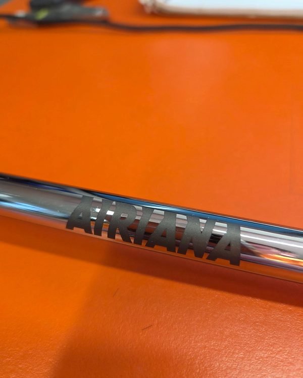 A chrome ratchet handle fiber-engraved with the name ADRIANA in bold block letters.