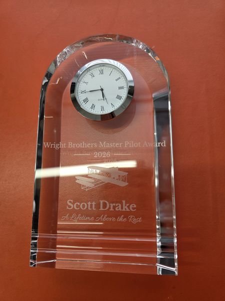 The Wright Brothers Master Pilot Award standing on its own, a domed crystal clock engraved for Scott Drake, 2026.